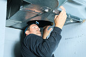 man cleaning duct